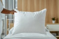 African hand holding white pillow in minimalist bedroom Royalty Free Stock Photo