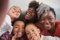 African horizontal extended family smiling and taking a selfie at home. Royalty Free Stock Photo