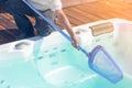 African hotel staff worker cleaning the jacuzzi. Maintenance