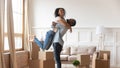 African husband lifting up wife happy family celebrating relocation day Royalty Free Stock Photo