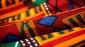 African Kente cloth, a vibrant and richly patterned fabric from Ghana, featuring bold and colorful interwoven geometric