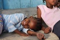 African kid with a happy face while the other is angry