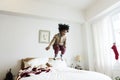 African kid having a fun time jumping on a bed Royalty Free Stock Photo