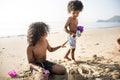 African kids building sand castle on the beach Royalty Free Stock Photo