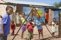 Children behind a fence in Namibia.Namibian cutge children, colorful dressed playing