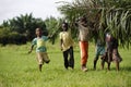 African kids help with carring palm leaves