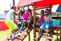 African kids playing on Jungle Gym and other park equipment at local public playground Royalty Free Stock Photo