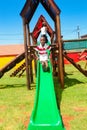 African kids playing on slides and other park equipment at local public playground Royalty Free Stock Photo