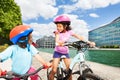 African kids riding bikes along a river embankment