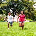 African kids running together in park. Royalty Free Stock Photo