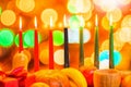 african Kwanzaa festive concept with decorate seven candles red, black and green, gift box, pumpkin, bowl and fruit on light blur