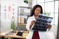 African lady general practitioner examining patient& x27;s tomography in her office Royalty Free Stock Photo