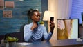 African lady having virtual meeting using phone Royalty Free Stock Photo