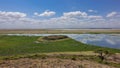 African landscape. The lake reflects the blue sky and clouds. Royalty Free Stock Photo