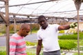 African and Latino men garden workers berating