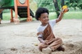 African little boy smile and enjoy playing sand with toys loader on playground outdoors in the park