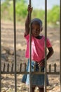 African little child standing near fence
