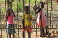 African little children standing near fence