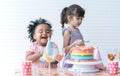 African little cute child girl laughing, enjoy eating rainbow cake, sugar candies and jelly on birthday party. Kids have fun Royalty Free Stock Photo