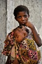 African little cute girl carrying baby brother