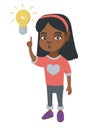 African little girl pointing at the lightbulb. Royalty Free Stock Photo