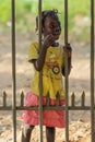 African little girl standing near fence