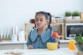 African little kid girl having fun with food and vegetables at kitchen, holding tomato, make a pucker lips, kissing. Cute child Royalty Free Stock Photo