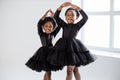 African little ladies in black dress dancing ballet indoors