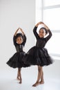 African little ladies in black dress dancing ballet indoors