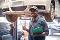 African maintenance male checking tire service via insurance system at garage