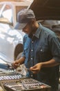 African maintenance male are choosing tools to repair the car