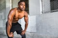 Lifestyle of african american athlete preparing for run, jogging, intense conviction, determination, serious stare, powerful eyes Royalty Free Stock Photo