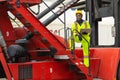 African male dock worker control loading containers cargo at warehouse container shipyard. Marine and carrier staff employee.