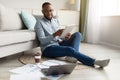 African Male Freelancer Using Digital Tablet Working Online From Home Royalty Free Stock Photo