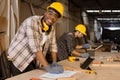 African male happy worker wood furniture maker staff, wood panel construction site work men team