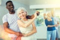 African male novice student of fitness studio practices paired Latin American rumba dance Royalty Free Stock Photo