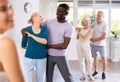 African male novice student of fitness studio practices paired Latin American rumba dance Royalty Free Stock Photo