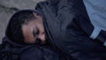 African male refugee lying street ground covered with sleeping bag, homelessness Royalty Free Stock Photo