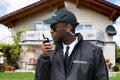 African Male Security Guard Talking On Walkie Talkie Royalty Free Stock Photo