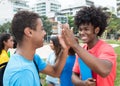 African male student give high five to indian student