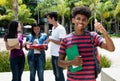 African male student showing thumb with group of other international students Royalty Free Stock Photo