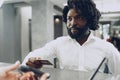 African man businessman paying for the stay in hotel with credit card Royalty Free Stock Photo