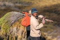 African man carries wood dry season