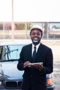 African man construction engineer worker standing and use teblet with the car Royalty Free Stock Photo