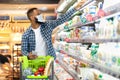 African Man Doing Grocery Shopping In Supermarket, Wearing Face Mask Royalty Free Stock Photo