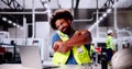 African Man Doing Stretch Exercise At Automated Factory