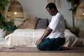 African man doing yoga exercise performing Upward abdominal lock, Uddiyana Bandha.