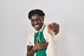 African man with dreadlocks standing over isolated background laughing at you, pointing finger to the camera with hand over body, Royalty Free Stock Photo