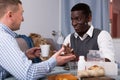 African man enjoying ÃÂonversation with friend at home Royalty Free Stock Photo