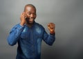 African man excited whilst receiving a call on a mobile phone